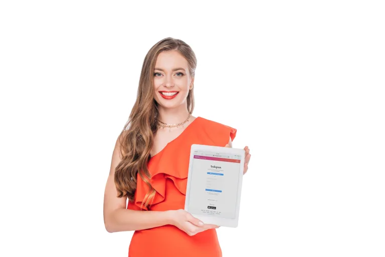 elegant smiling young woman holding digital tablet with instagram website on screen isolated on