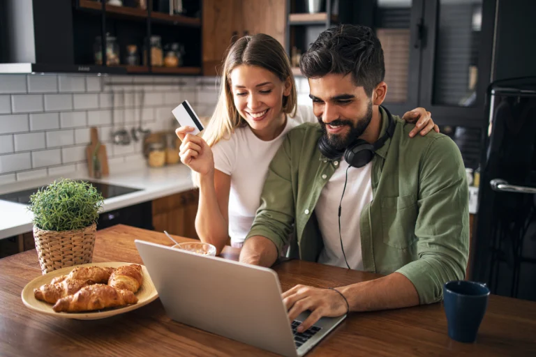 A happy couple in a kitchen buying products at tiktok shop oniine